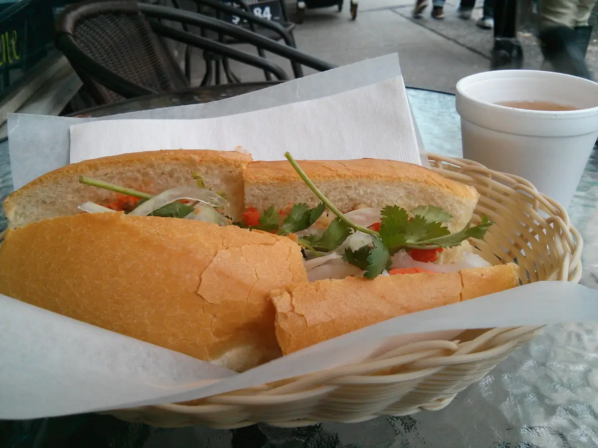 Vietnamese bánh mì filled with pork meatballs, pickled vegetables, cucumber and coriander